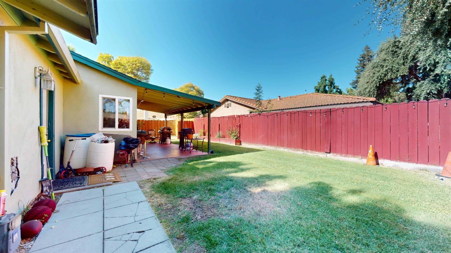 4005 Honey Creek Road Modesto, CA 95356 - Photo 21 of 25 a view of a backyard with table and chairs under an umbrella