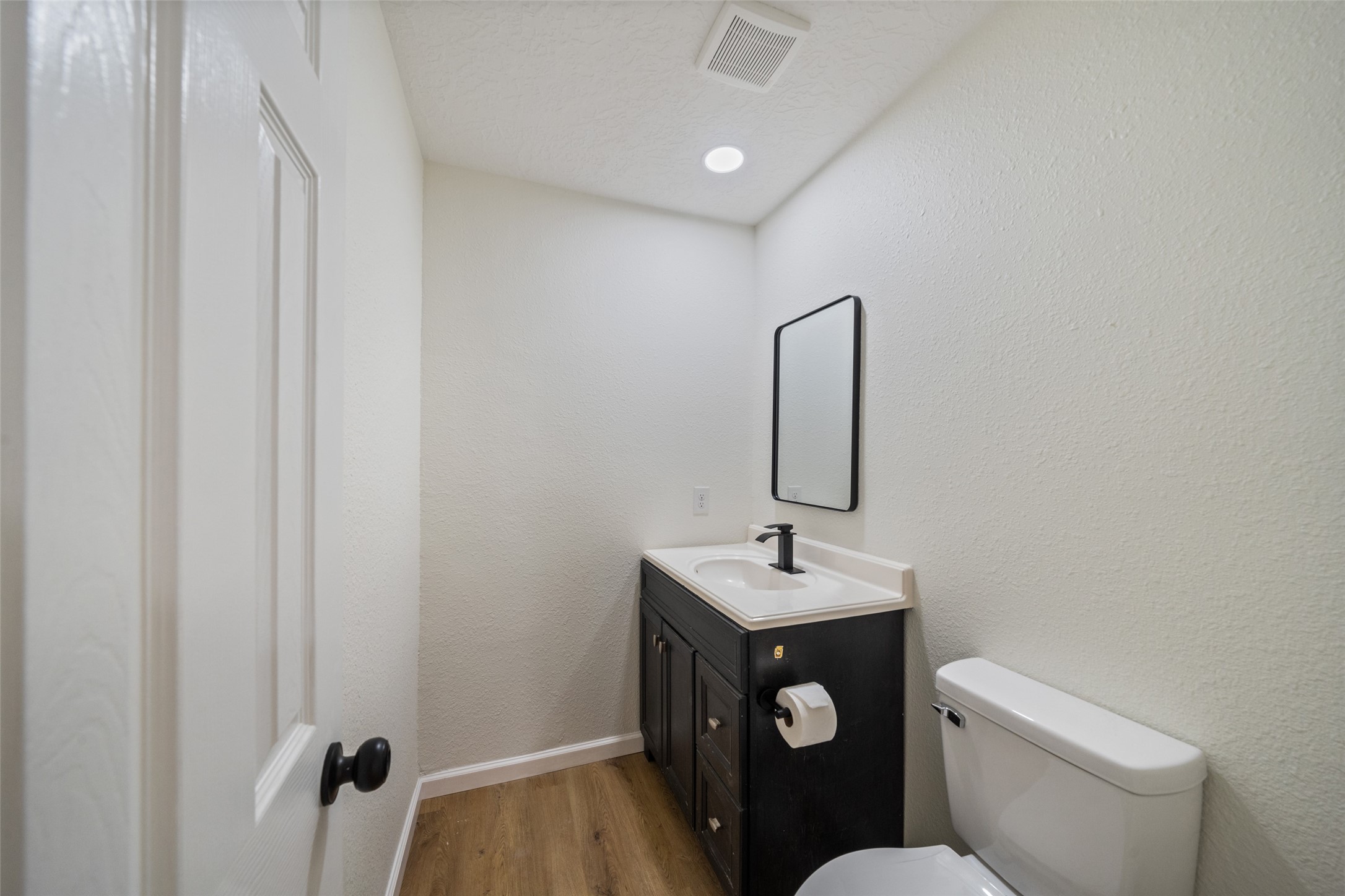 238 Point Clear Drive Conroe, TX 77304 - Photo 11 of 20 a bathroom with a toilet sink vanity and mirror