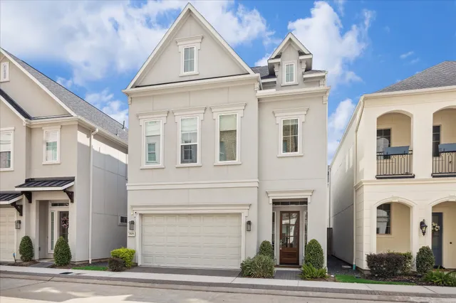 a view of a white house with large windows