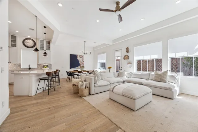 a living room with fireplace furniture and a large window