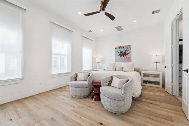 a bedroom with furniture and wooden floor