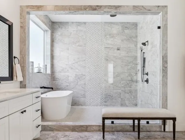 a bathroom with a bathtub shower sink and mirror