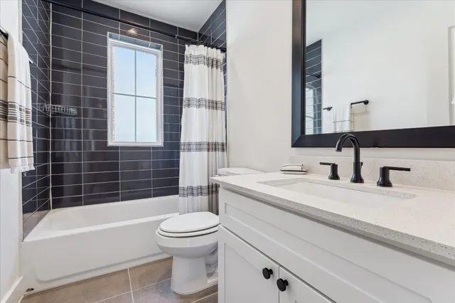 a bathroom with a granite countertop toilet a sink and bathtub
