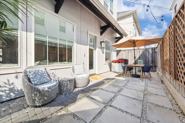 a building outdoor space with patio furniture and potted plants