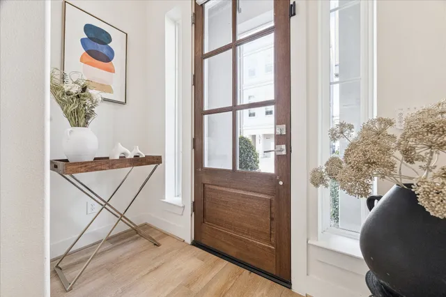 a view of a hallway to a livingroom with furniture