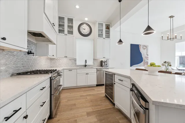 a kitchen with a white cabinets stove and sink