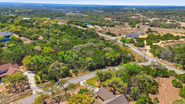 an aerial view of a houses with a yard