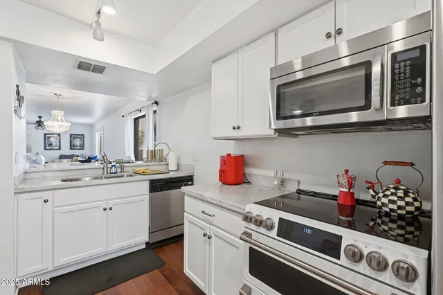 a kitchen with stainless steel appliances granite countertop a stove and a microwave