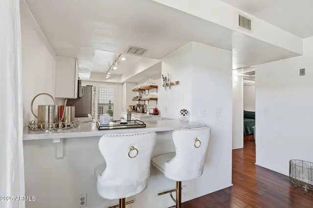 a kitchen with stainless steel appliances granite countertop a sink and a refrigerator