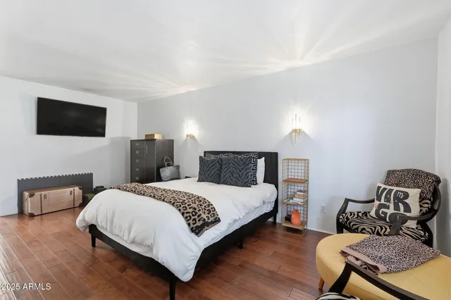 a bedroom with a bed and a television