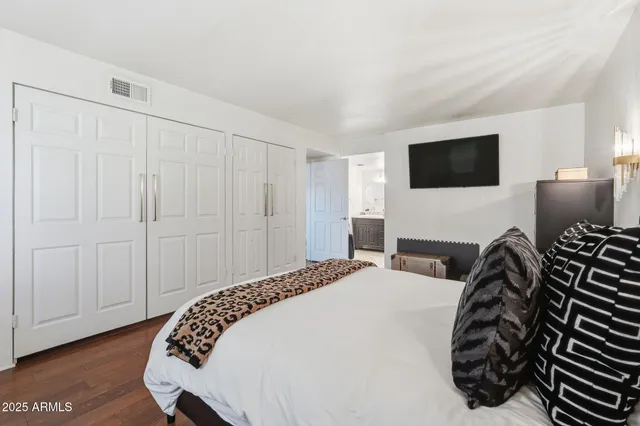 a bedroom with a bed and a television