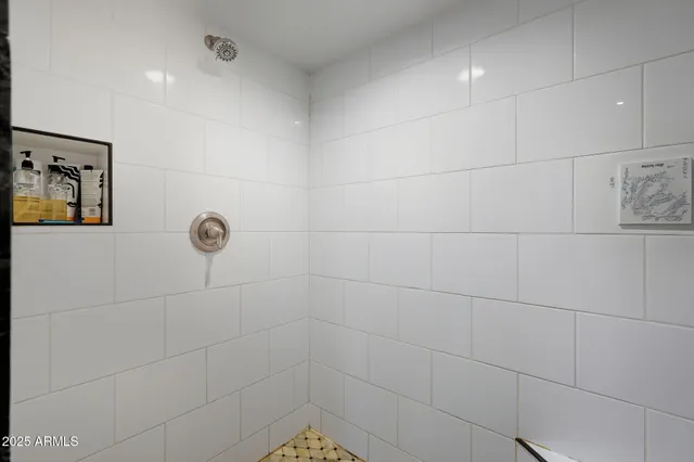 a bathroom with a granite countertop toilet sink and mirror