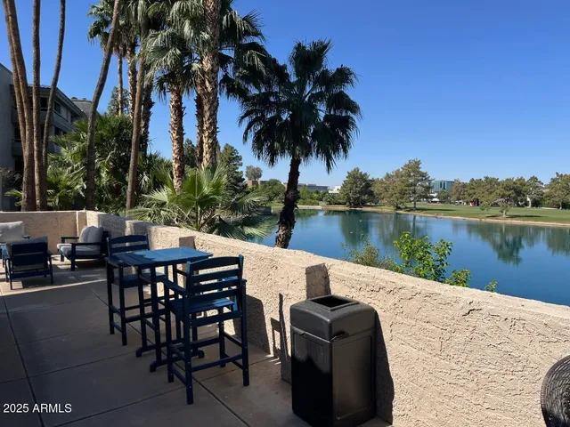 a roof deck with a table and chairs