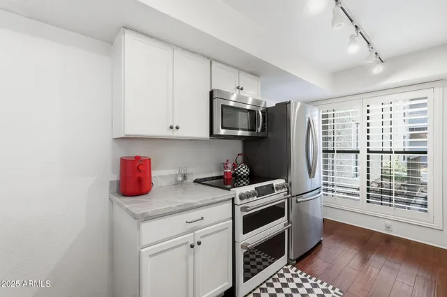 a kitchen with a stove a sink and a refrigerator