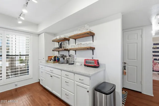 a kitchen with cabinets and window