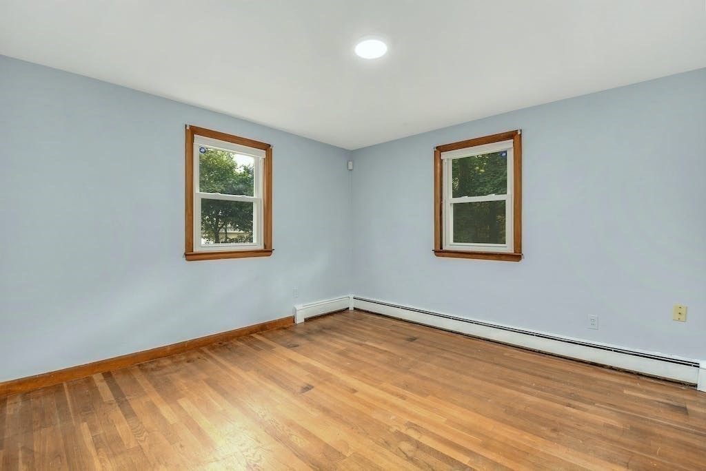 30 Old Marlboro Road Maynard, MA 01754 - Photo 11 of 34 a view of empty room with wooden floor and fan