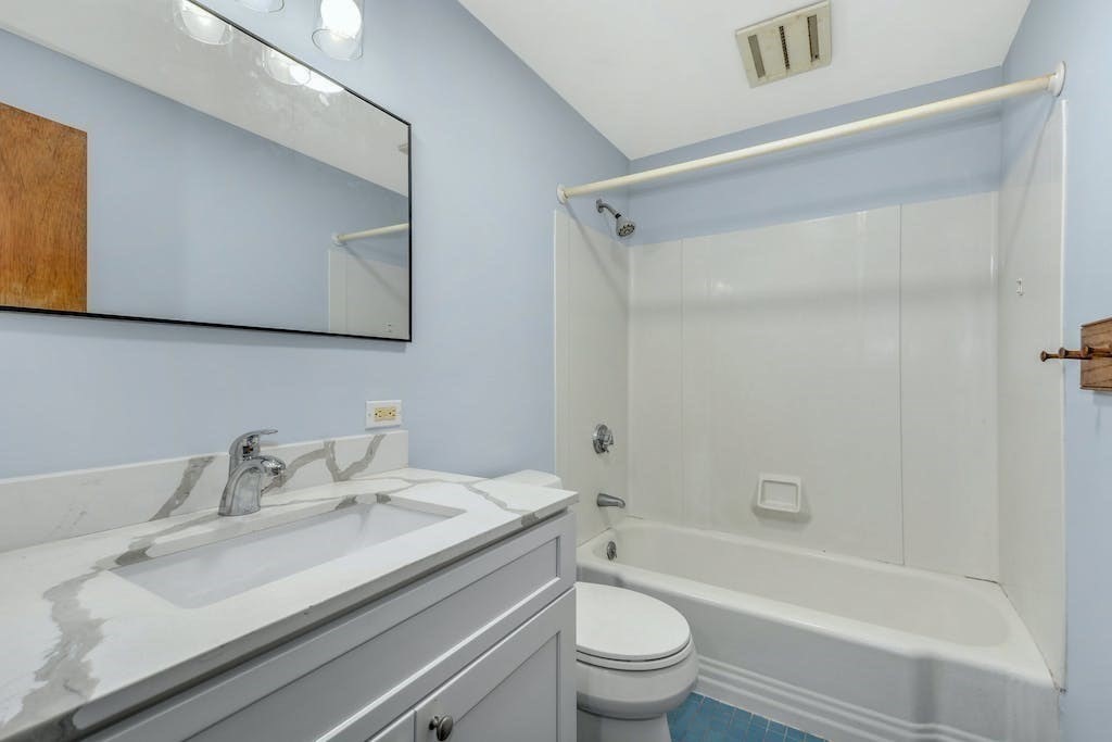 30 Old Marlboro Road Maynard, MA 01754 - Photo 12 of 34 a bathroom with a granite countertop sink toilet and shower