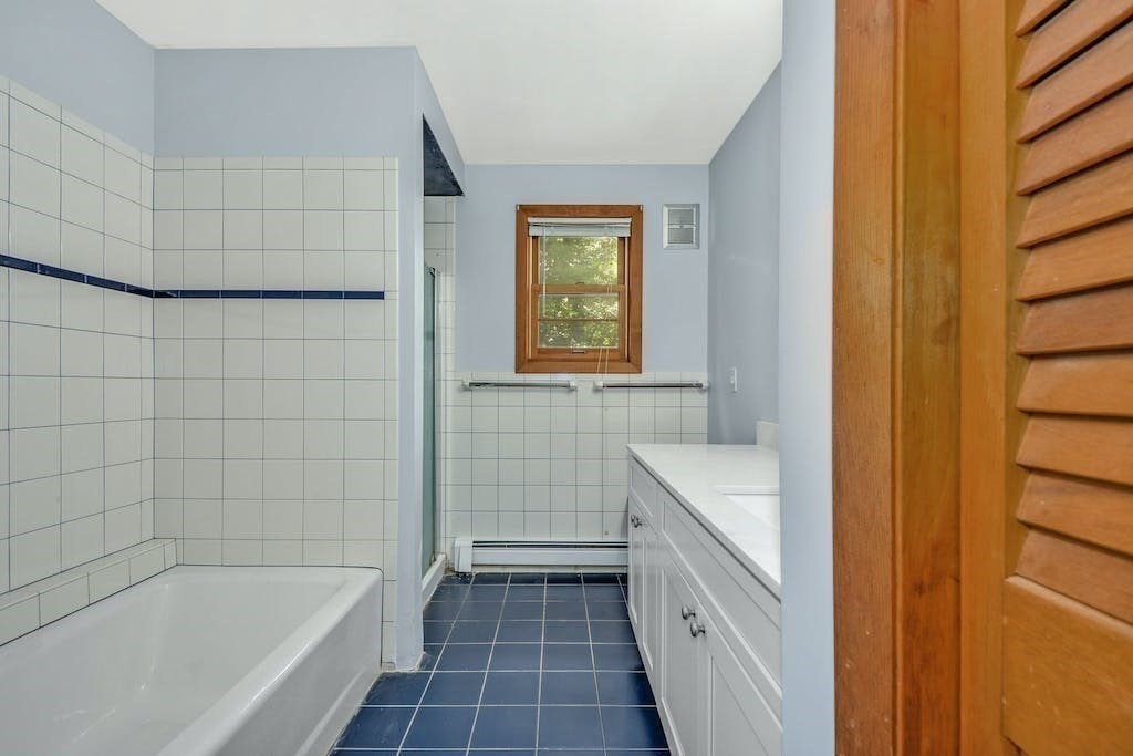 30 Old Marlboro Road Maynard, MA 01754 - Photo 18 of 34 a bathroom with a sink a toilet and shower