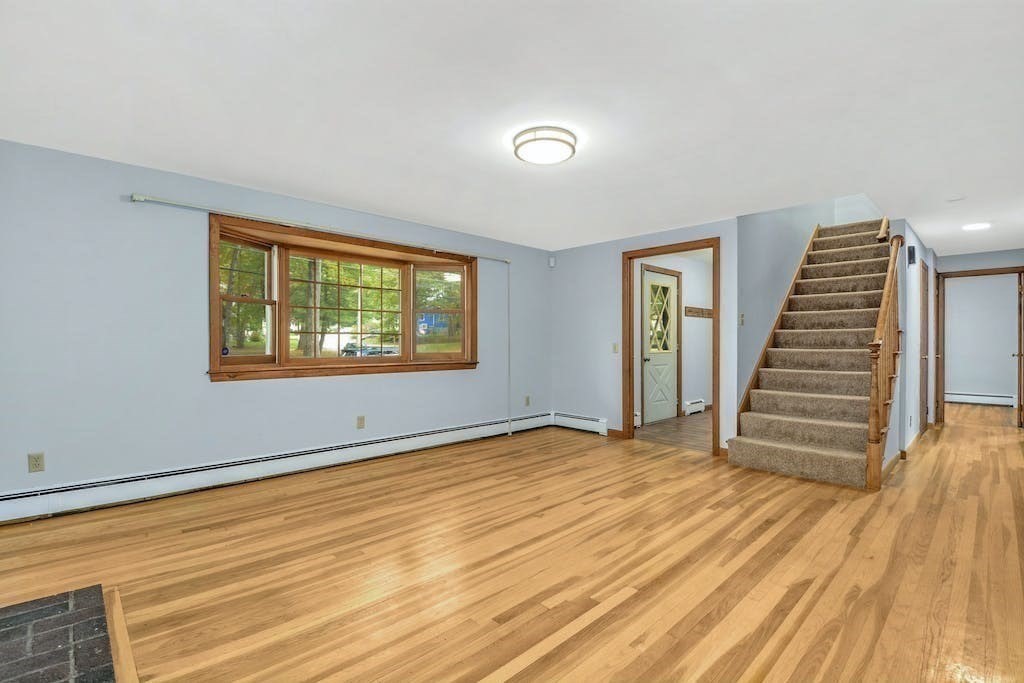 30 Old Marlboro Road Maynard, MA 01754 - Photo 5 of 34 a view of an empty room with wooden floor and a window
