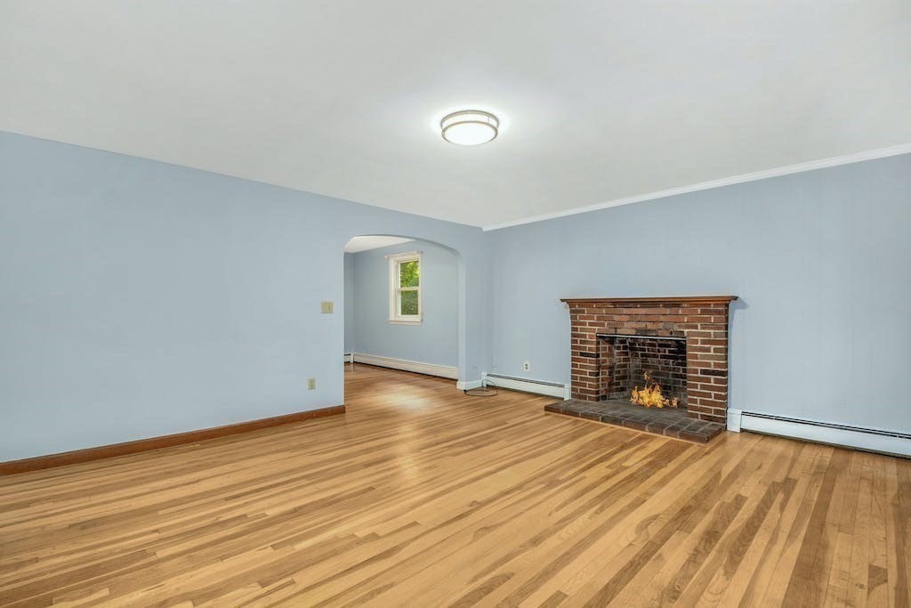 30 Old Marlboro Road Maynard, MA 01754 - Photo 6 of 34 an empty room with wooden floor fireplace and windows