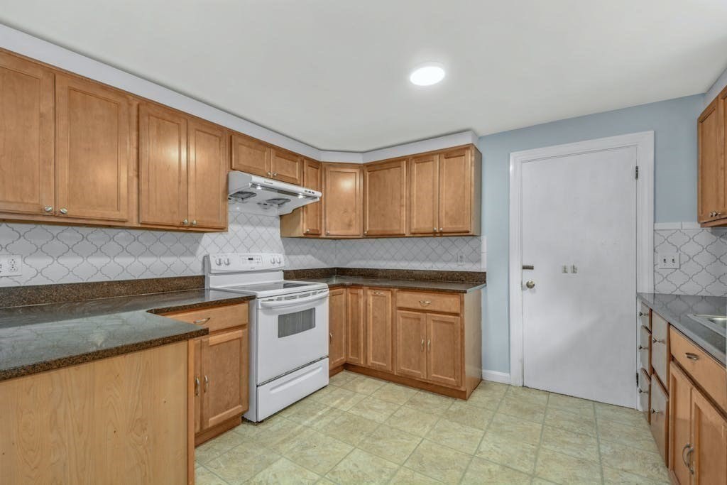 30 Old Marlboro Road Maynard, MA 01754 - Photo 9 of 34 a kitchen with stainless steel appliances granite countertop a stove a sink and a refrigerator
