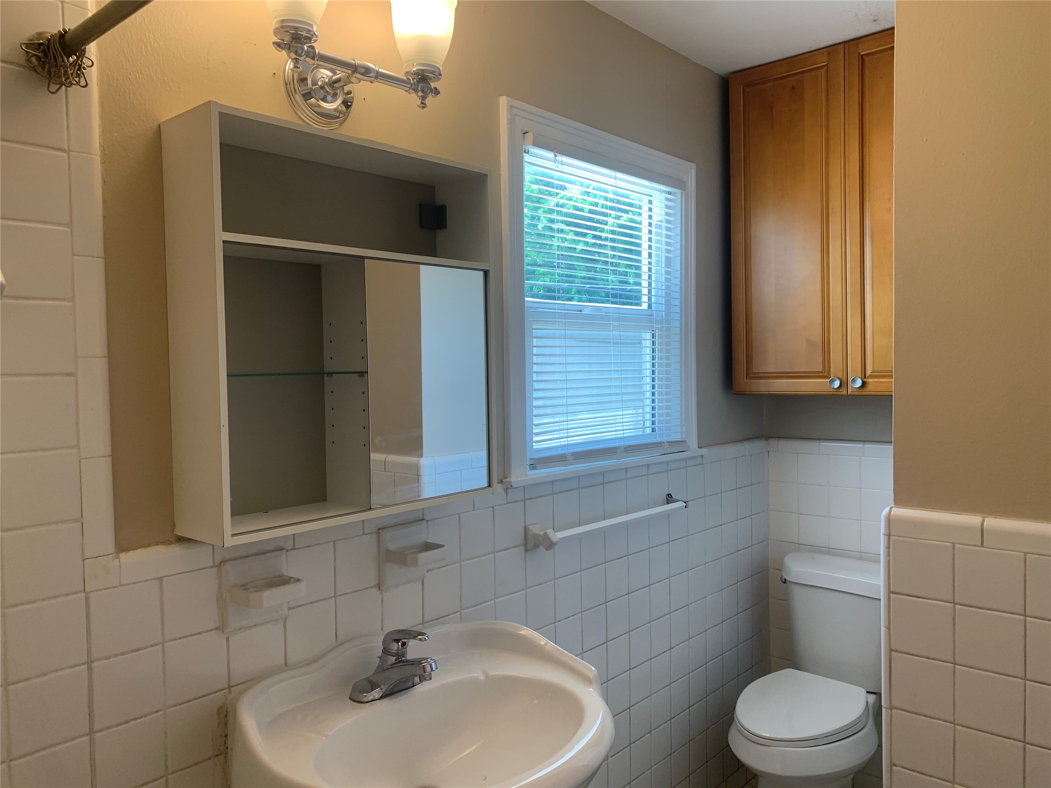 307 Avondale Street, Unit 2 5 Houston, TX 77006 - Photo 21 of 30 Bathroom has storage cabinet over toilet for linens and mirrored storage area over sink too.