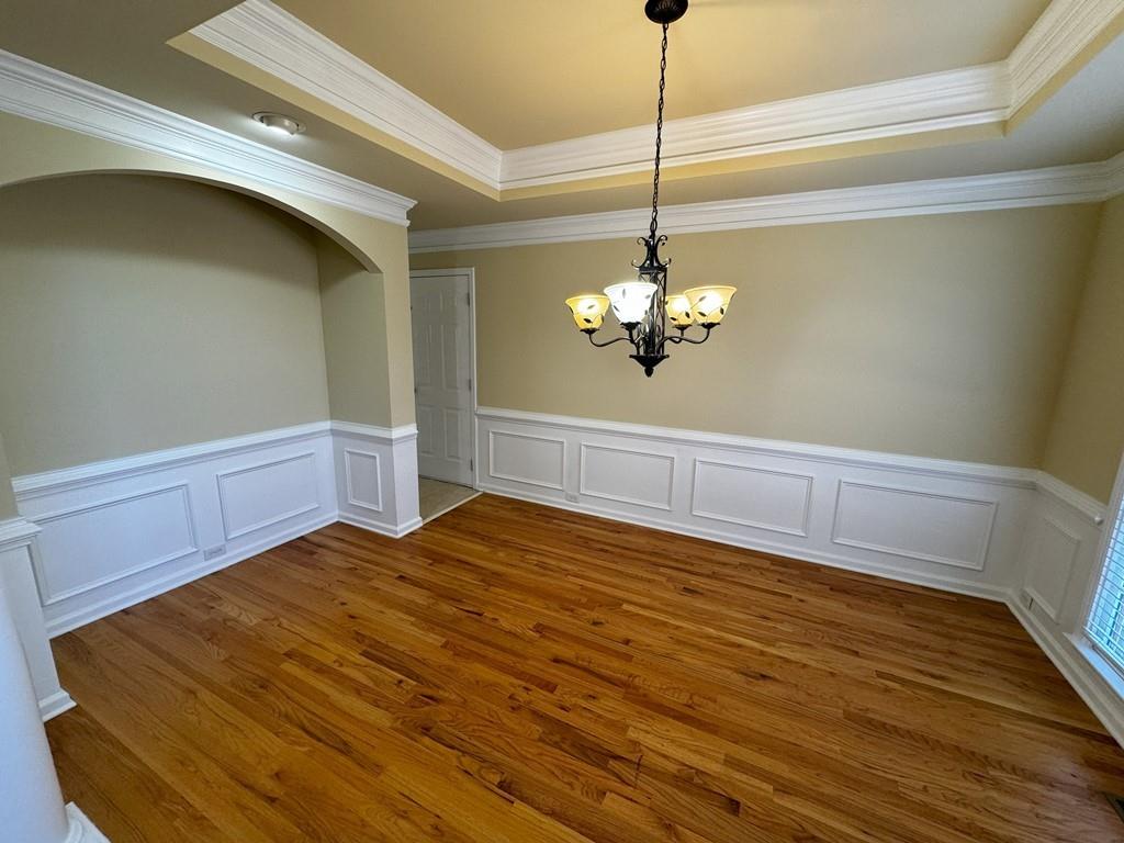 2620 Springmonte Place Cumming, GA 30041 - Photo 7 of 67 a view of a room with wooden floor and chandelier