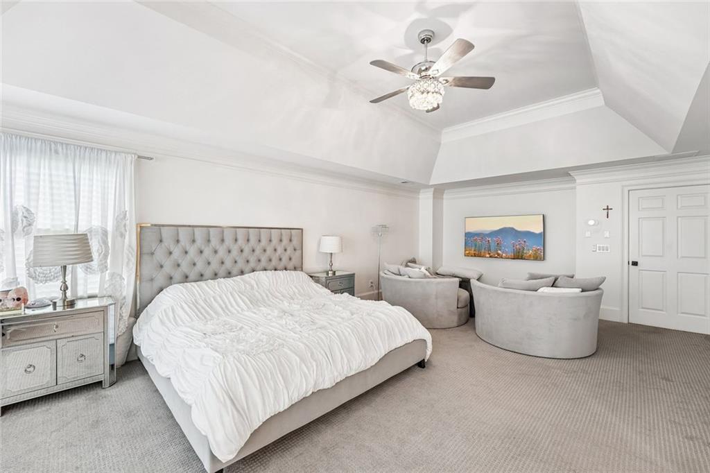 1091 Fieldstone Trail Milton, GA 30004 - Photo 32 of 84 a spacious bedroom with a bed and a chandelier