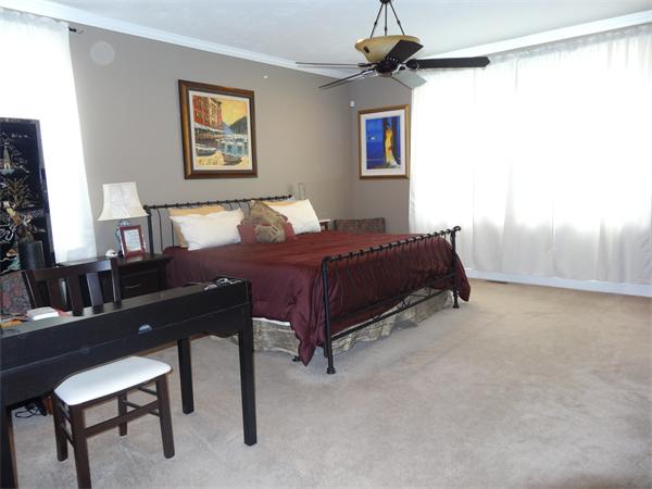 34 Draper Woods Road Sturbridge, MA 01518 - Photo 11 of 27 a bed room with a bed and a chair