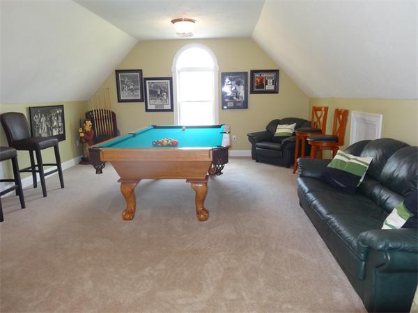 34 Draper Woods Road Sturbridge, MA 01518 - Photo 19 of 27 a room with furniture and a rug