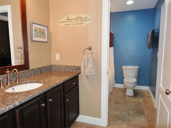 34 Draper Woods Road Sturbridge, MA 01518 - Photo 20 of 27 a bathroom with a granite countertop sink a toilet and a mirror