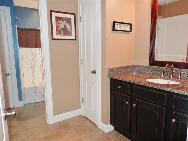 34 Draper Woods Road Sturbridge, MA 01518 - Photo 21 of 27 a bathroom with a granite countertop sink and a mirror