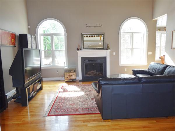 34 Draper Woods Road Sturbridge, MA 01518 - Photo 3 of 27 a living room with furniture and a fireplace