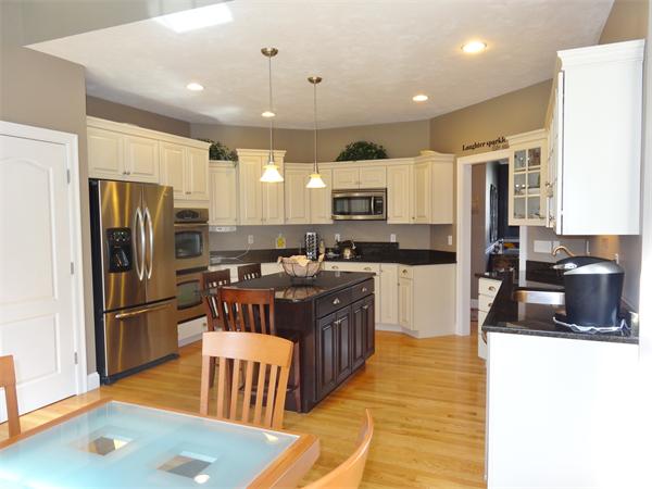 34 Draper Woods Road Sturbridge, MA 01518 - Photo 9 of 27 a kitchen with stainless steel appliances granite countertop a refrigerator a stove a sink a microwave and island