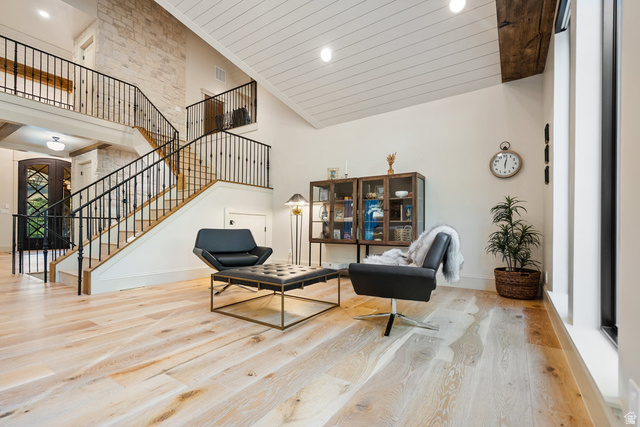 1141 South Oak Leaf Lane Springville, UT 84663 - Photo 35 of 147 Grand room/family room/living room... a light wood-finish flooring, a two-story staircase with dark wrought iron railings, and a prominent stone accent wall