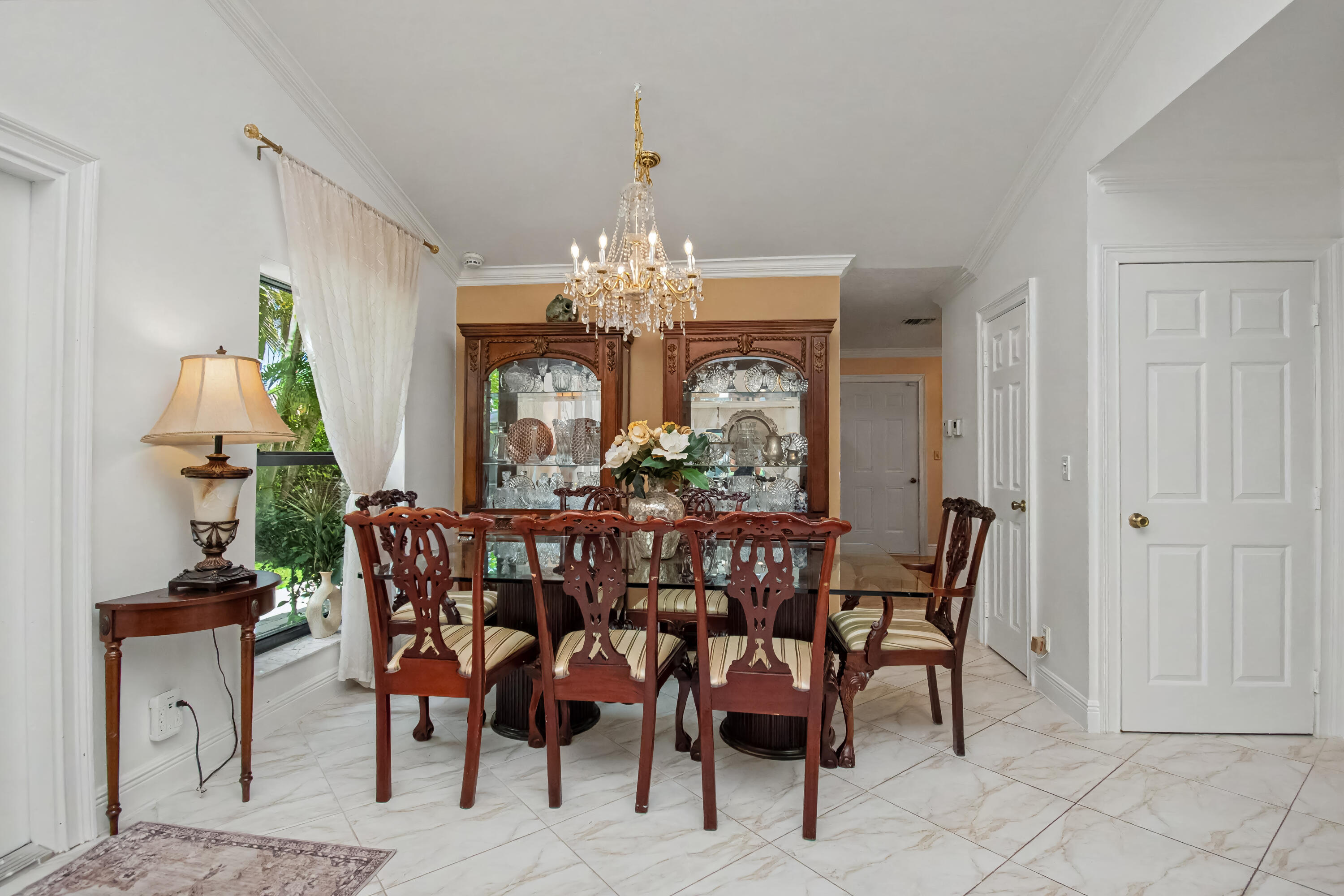 9708 Erica Court Boca Raton, FL 33496 - Photo 17 of 54 a view of a dining room with furniture and chandelier