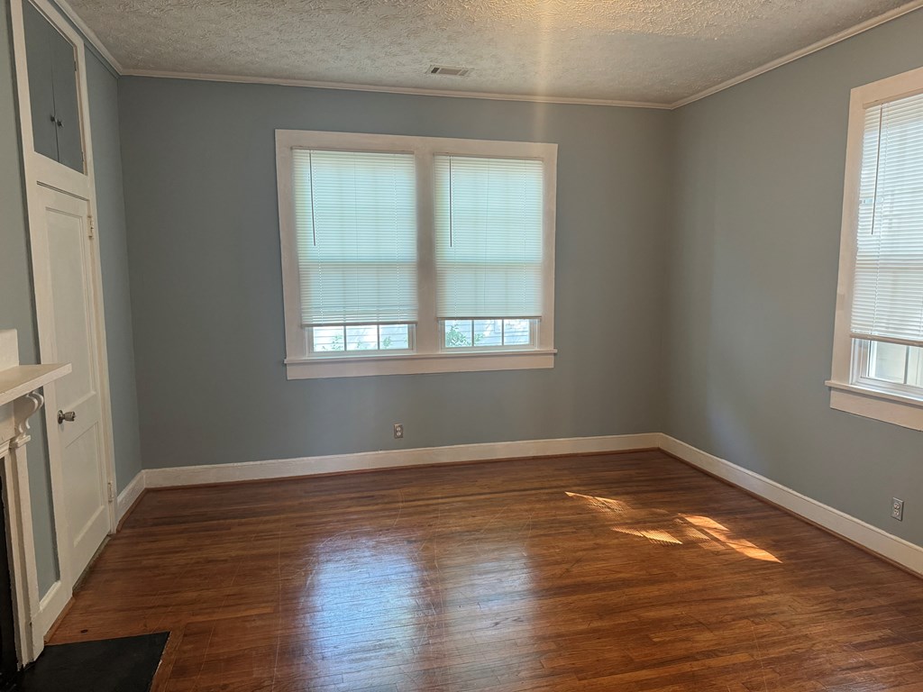 5 Magnolia Street Columbus, GA 31904 - Photo 3 of 14 an empty room with wooden floor and windows