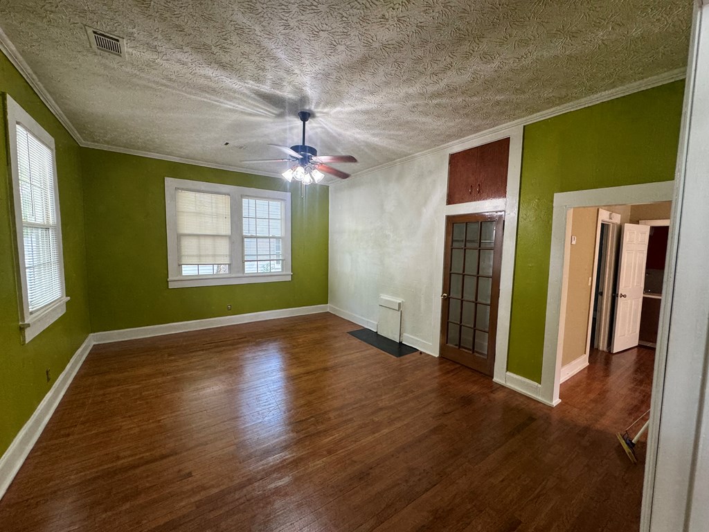 5 Magnolia Street Columbus, GA 31904 - Photo 10 of 14 a view of an empty room with a window and wooden floor
