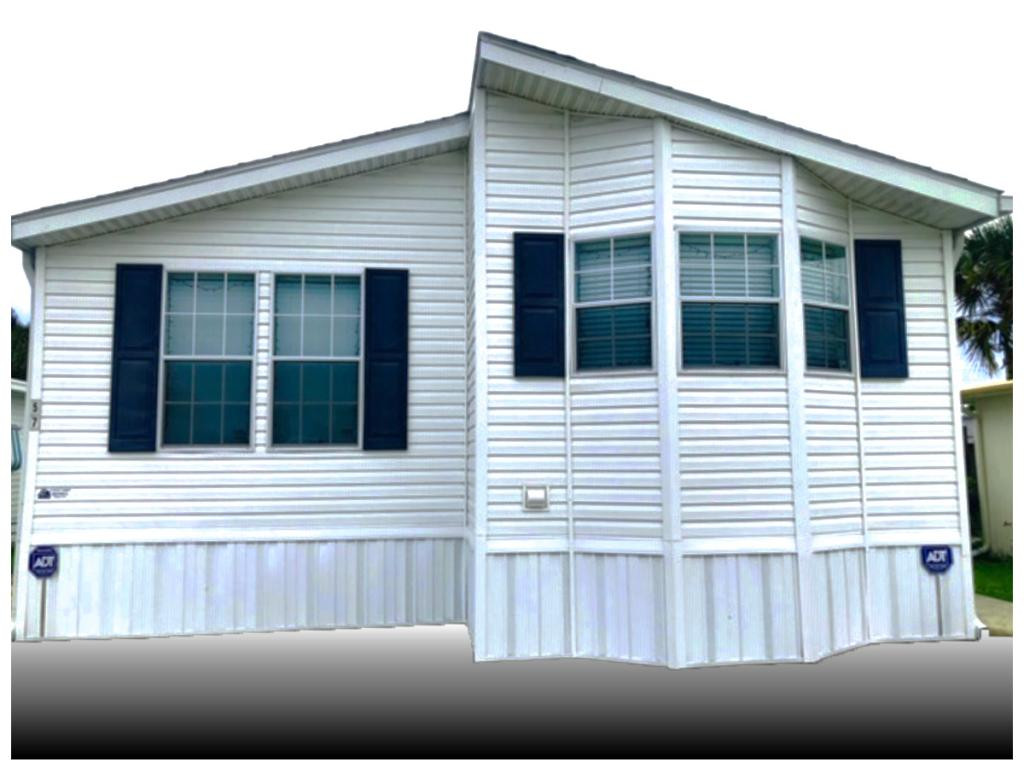 57 Temple Lane Naples, FL 34114 - Photo 2 of 18 a view of a house with a small yard