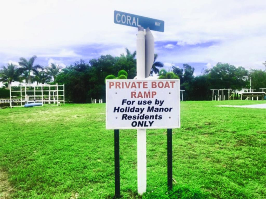 57 Temple Lane Naples, FL 34114 - Photo 12 of 18 a sign on the side of the park