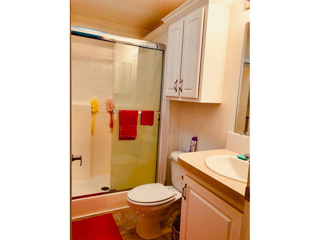 57 Temple Lane Naples, FL 34114 - Photo 16 of 18 a bathroom with a sink toilet and shower