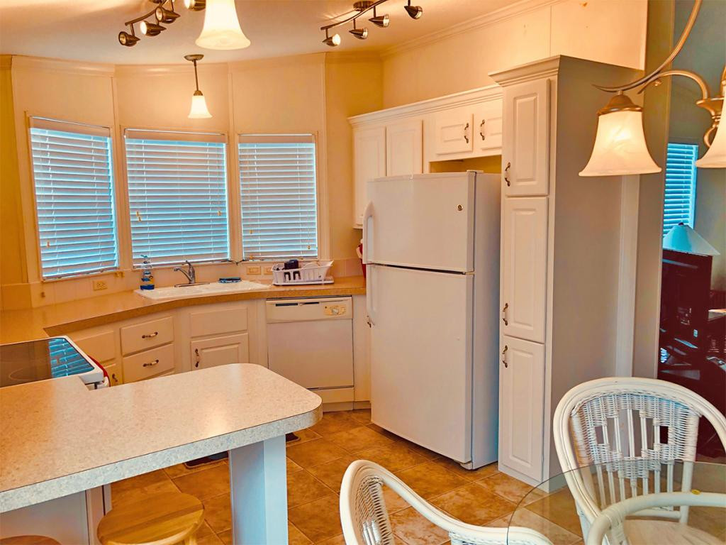 57 Temple Lane Naples, FL 34114 - Photo 6 of 18 a kitchen with a sink a refrigerator a stove a washer and dryer
