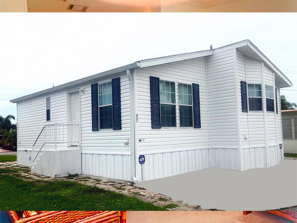 57 Temple Lane Naples, FL 34114 - Photo 9 of 18 a view of a house with a small yard and a large window