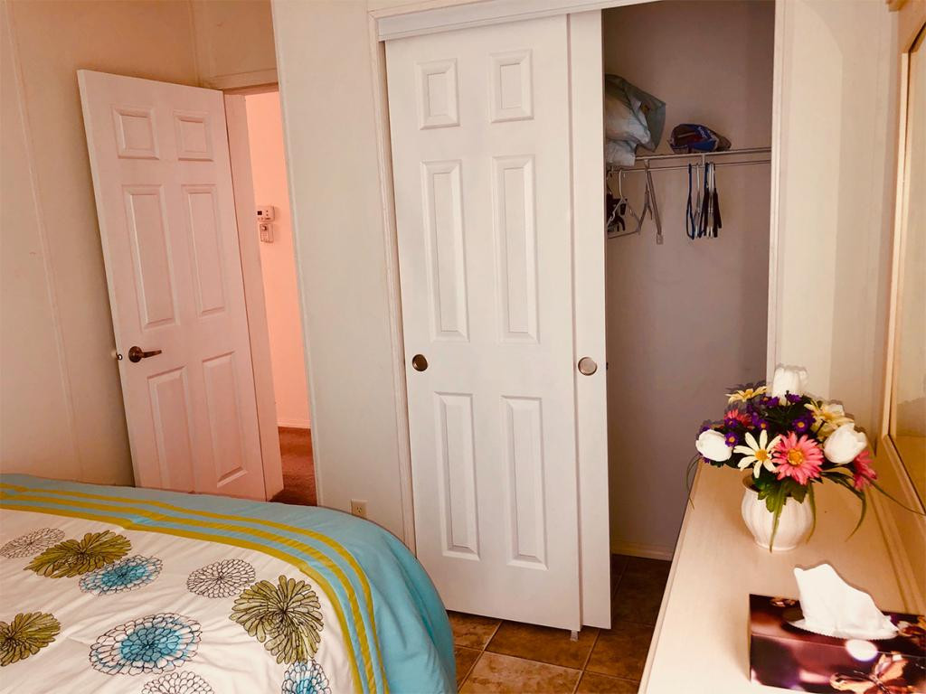 57 Temple Lane Naples, FL 34114 - Photo 10 of 18 a bedroom with a bed and a chandelier