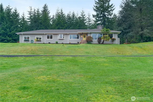 a front view of house with a garden and deck