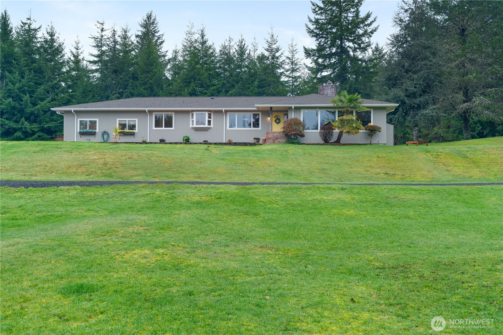 a front view of house with a garden and deck