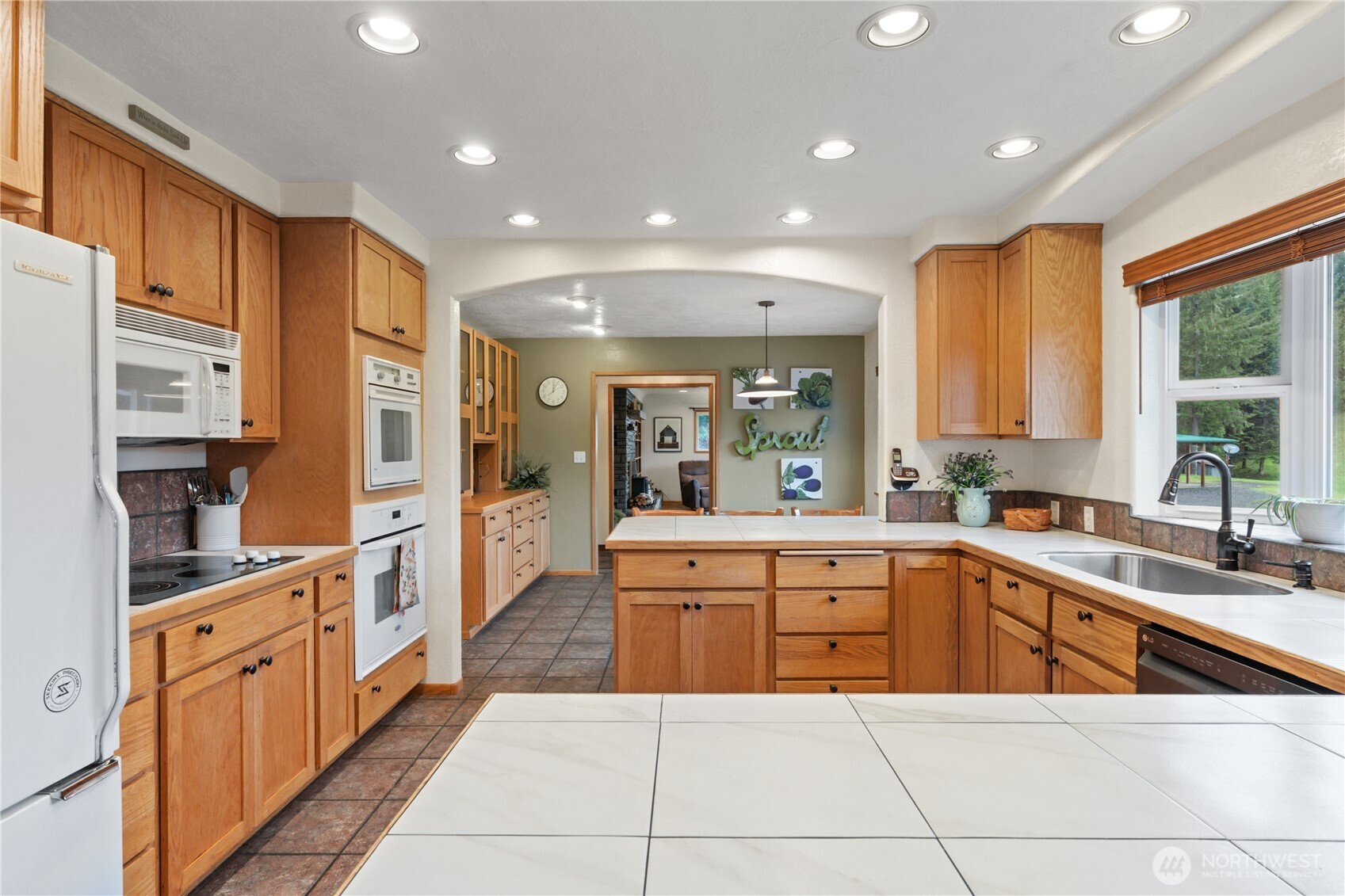245 Joe Rocky Road Raymond, WA 98577 - Photo 11 of 40 a large kitchen with stainless steel appliances lots of counter space and windows