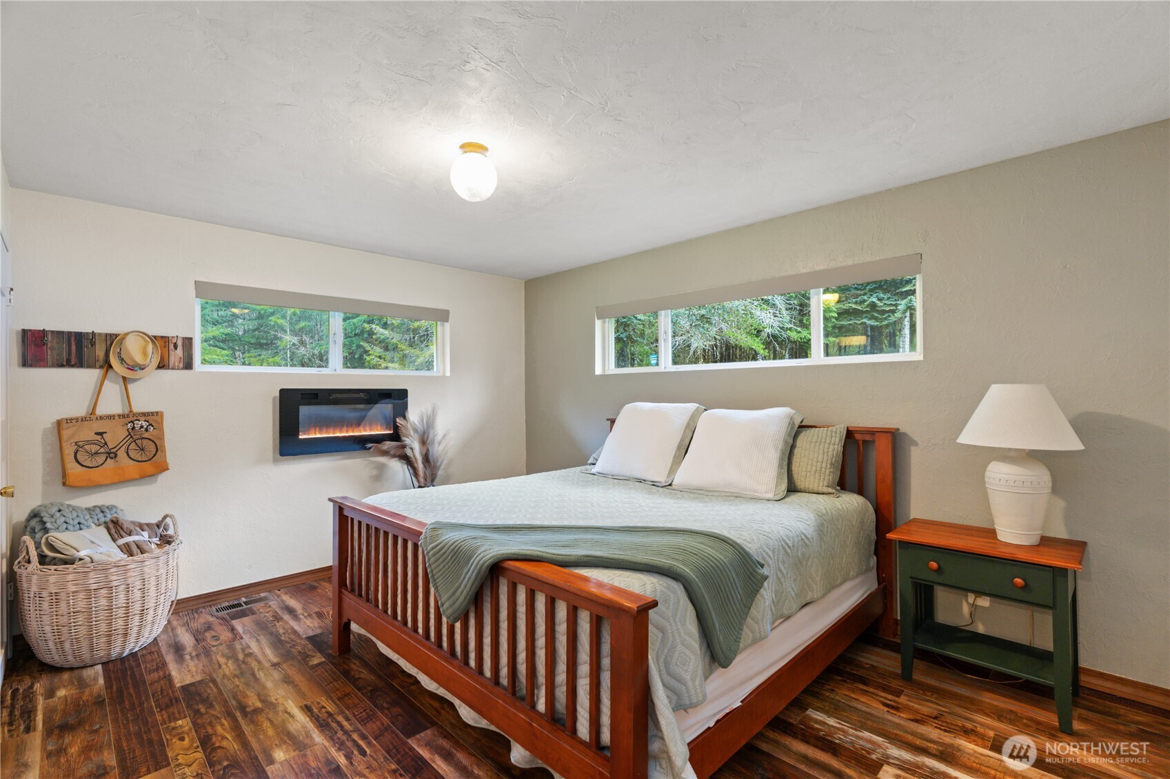 245 Joe Rocky Road Raymond, WA 98577 - Photo 13 of 40 a bedroom with a bed a chandelier and a window