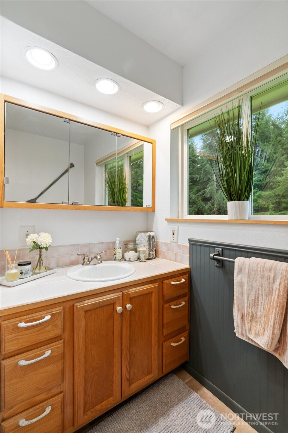 245 Joe Rocky Road Raymond, WA 98577 - Photo 21 of 40 a bathroom with a granite countertop sink vanity and mirror