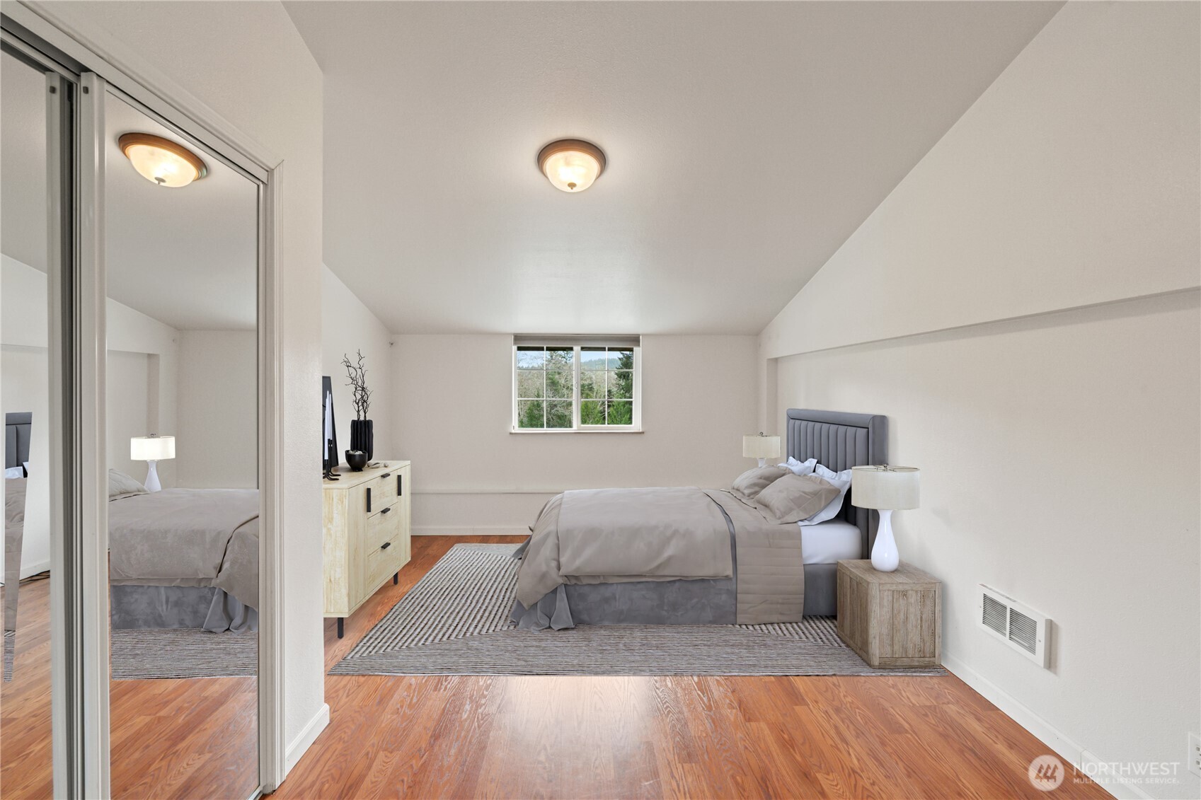 245 Joe Rocky Road Raymond, WA 98577 - Photo 31 of 40 a bedroom with a bed and a mirror